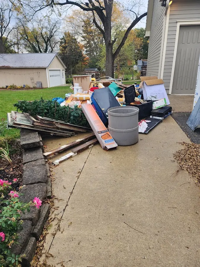 Dumpster being loaded with debris for 12 Yard Dumpster Rental in Brownsburg